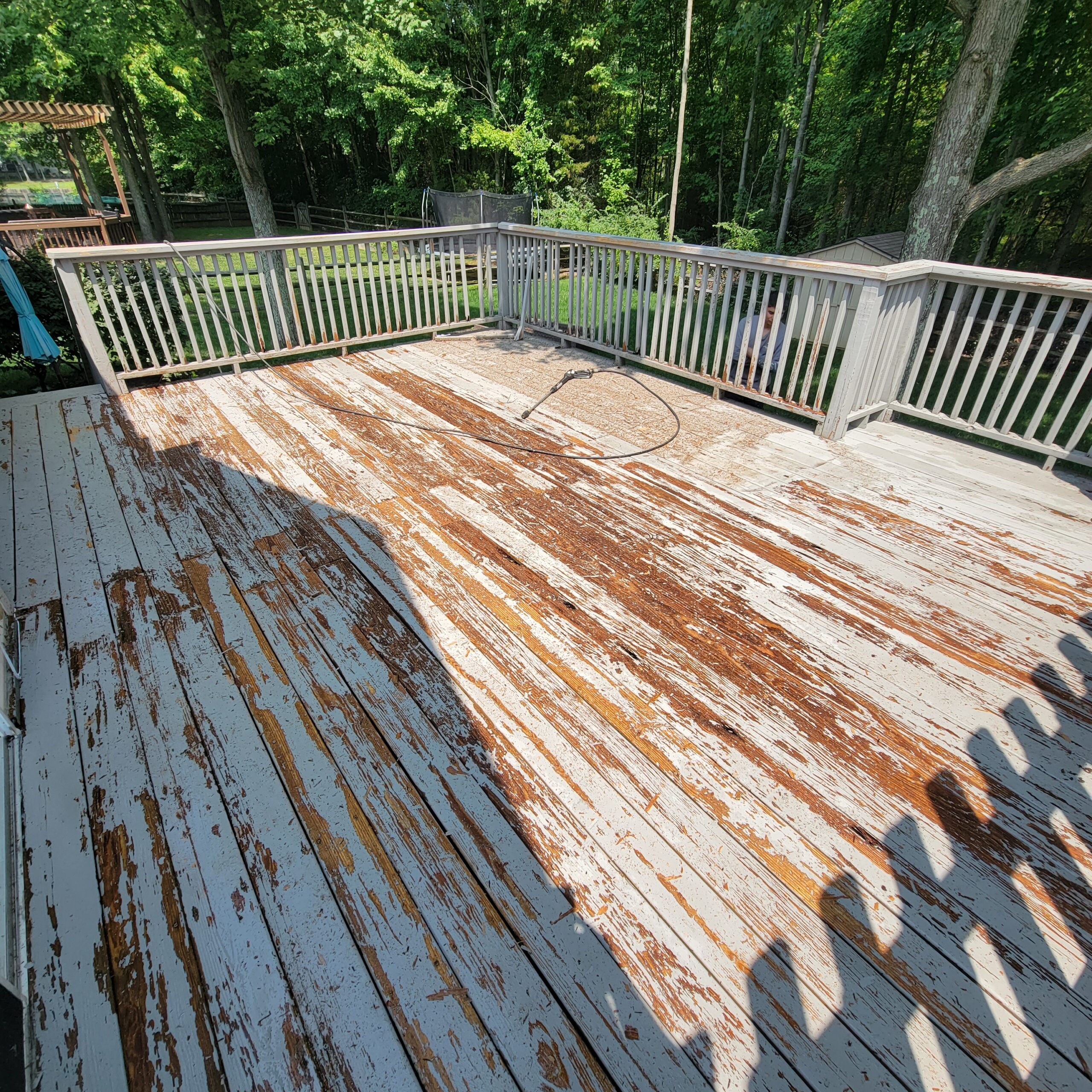 backyard deck with a bad case of peeling deck paint